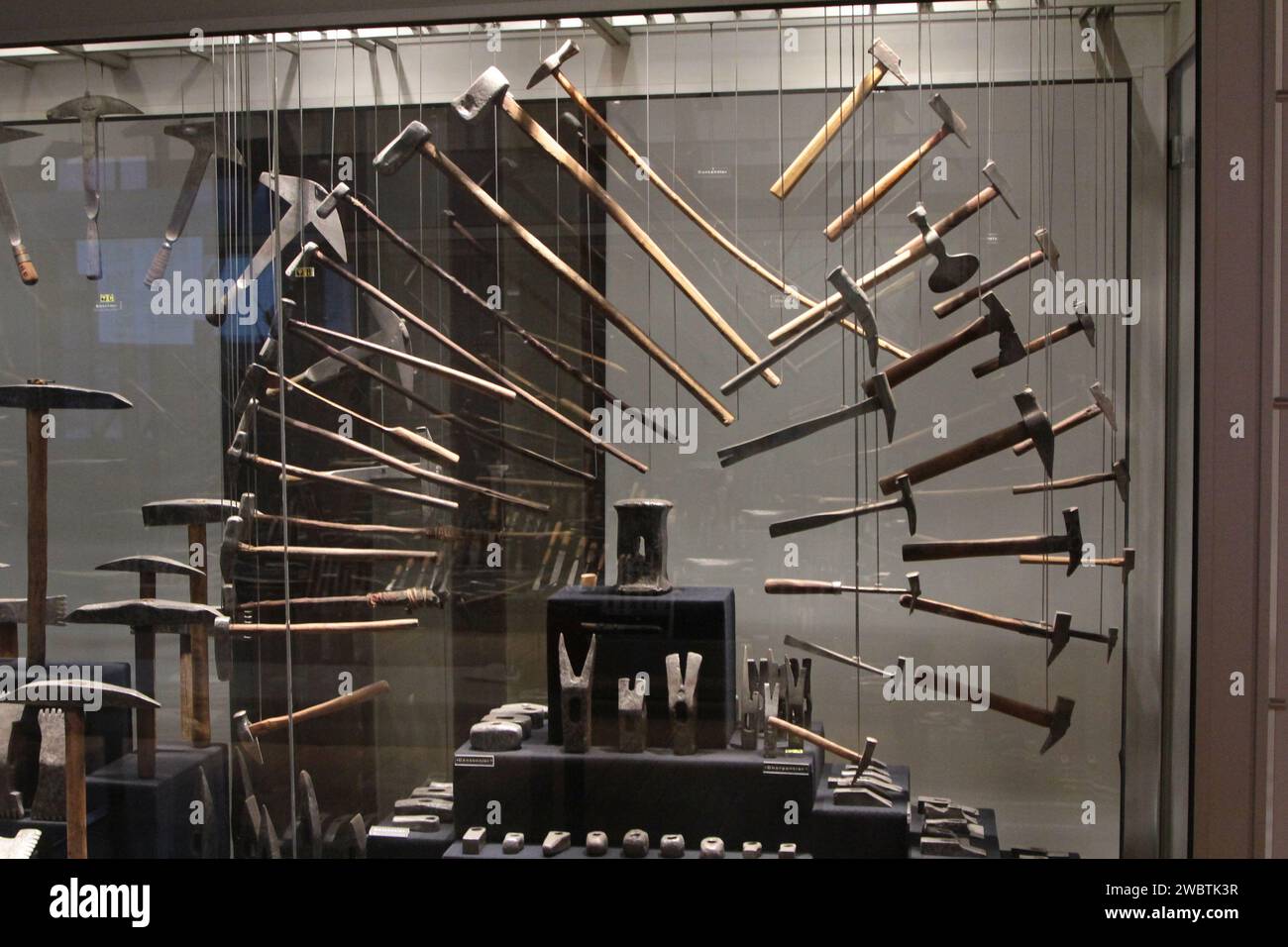 The way these hammers are displayed in the Musée de l'Outil (tool museum) in Troyes, France, reproduces the movement a user of this tool would make. Stock Photo