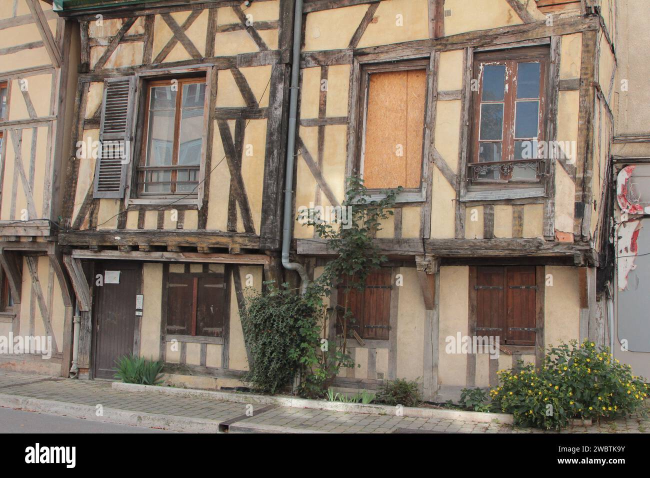 Medieval timber-framed houses needing some restoration at the eastern, less touristy, end of the rue Kléber in Troyes' historic city centre, France. Stock Photo