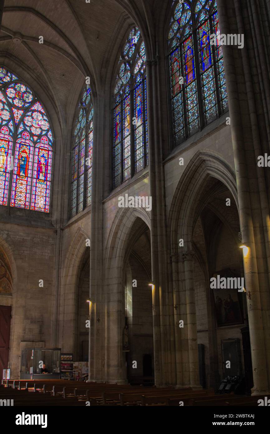 Stained-glass windows occupy almost half the height over the main entrance and the north wall of the nave in St Urbain Basilica, Troyes, France. Stock Photo