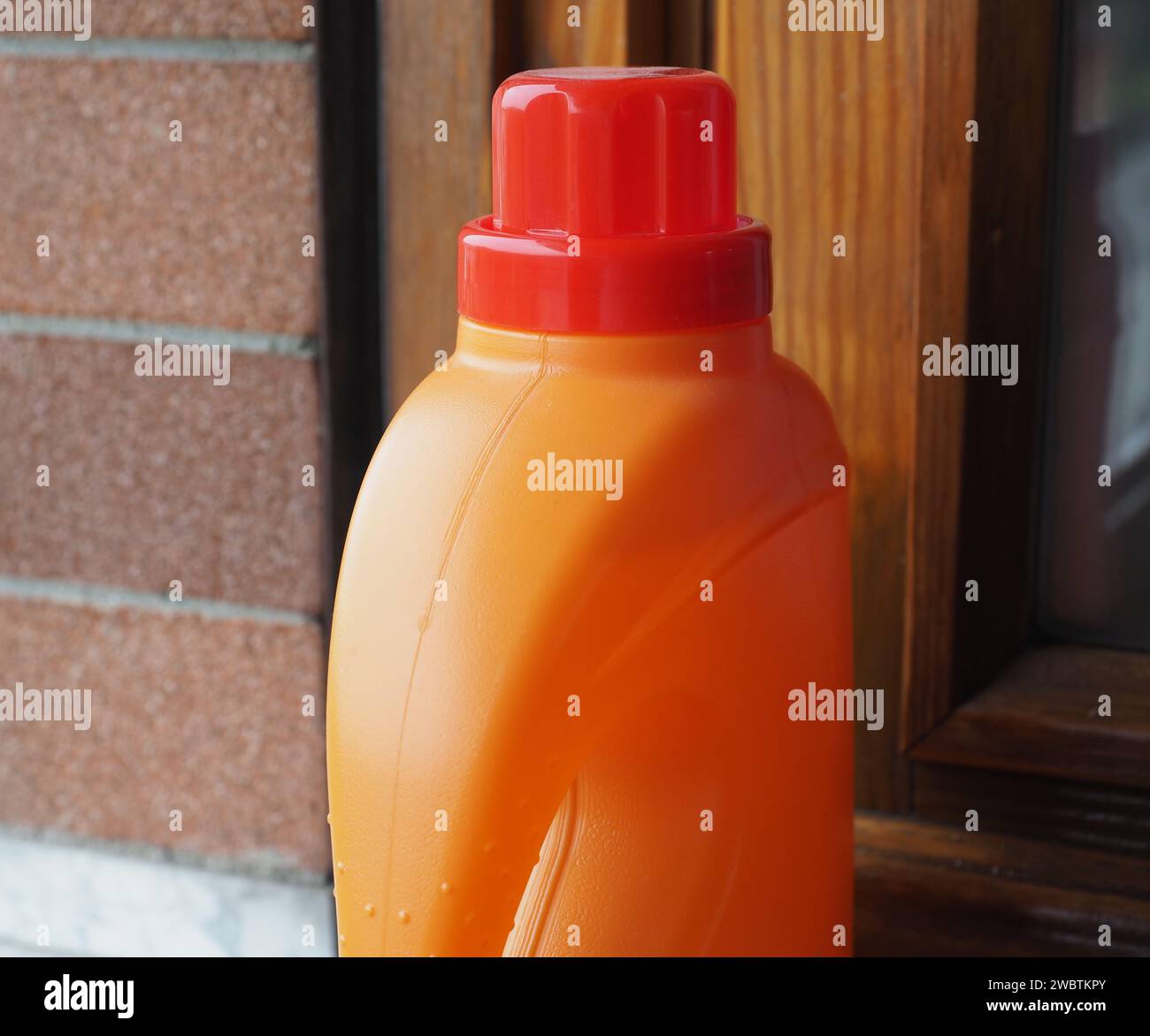 Disposable Single Use Rigid Orange Plastic Detergent Bottle Stock Photo