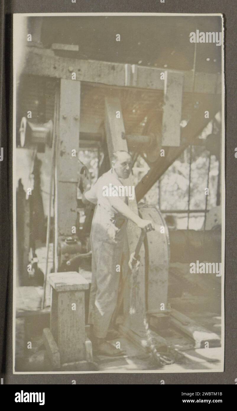 Wbtm Machine Man operates a machine with a lever, Anonymous, 1920 - 1930 photograph ...
