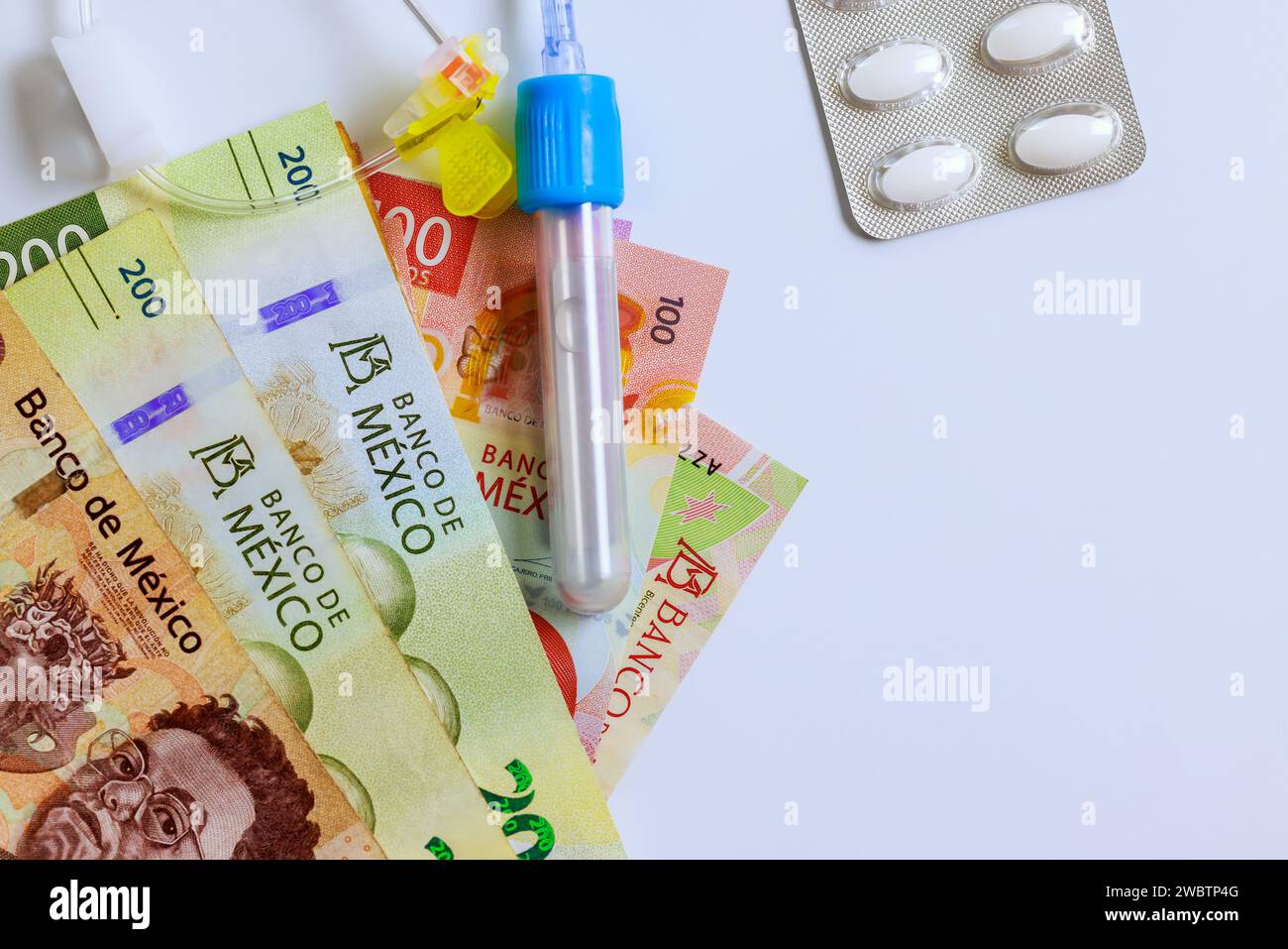 Medical treatment in Mexico costs a great deal money is of mexican cash banknotes pesos, drugs, pills Stock Photo