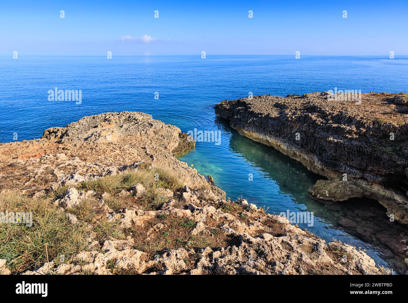 The most beautiful Apulian coast in Italy: Cala Corvino. Typical coastline near Monopoli : high and rocky coast characterized by small sandy coves wit Stock Photo