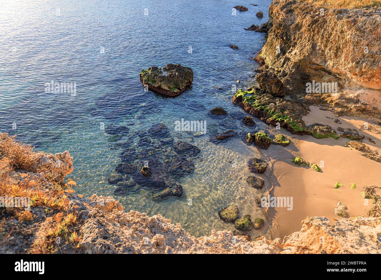 The most beautiful Apulian coast in Italy: Cala Corvino. Typical coastline near Monopoli : high and rocky coast characterized by small sandy coves. Stock Photo