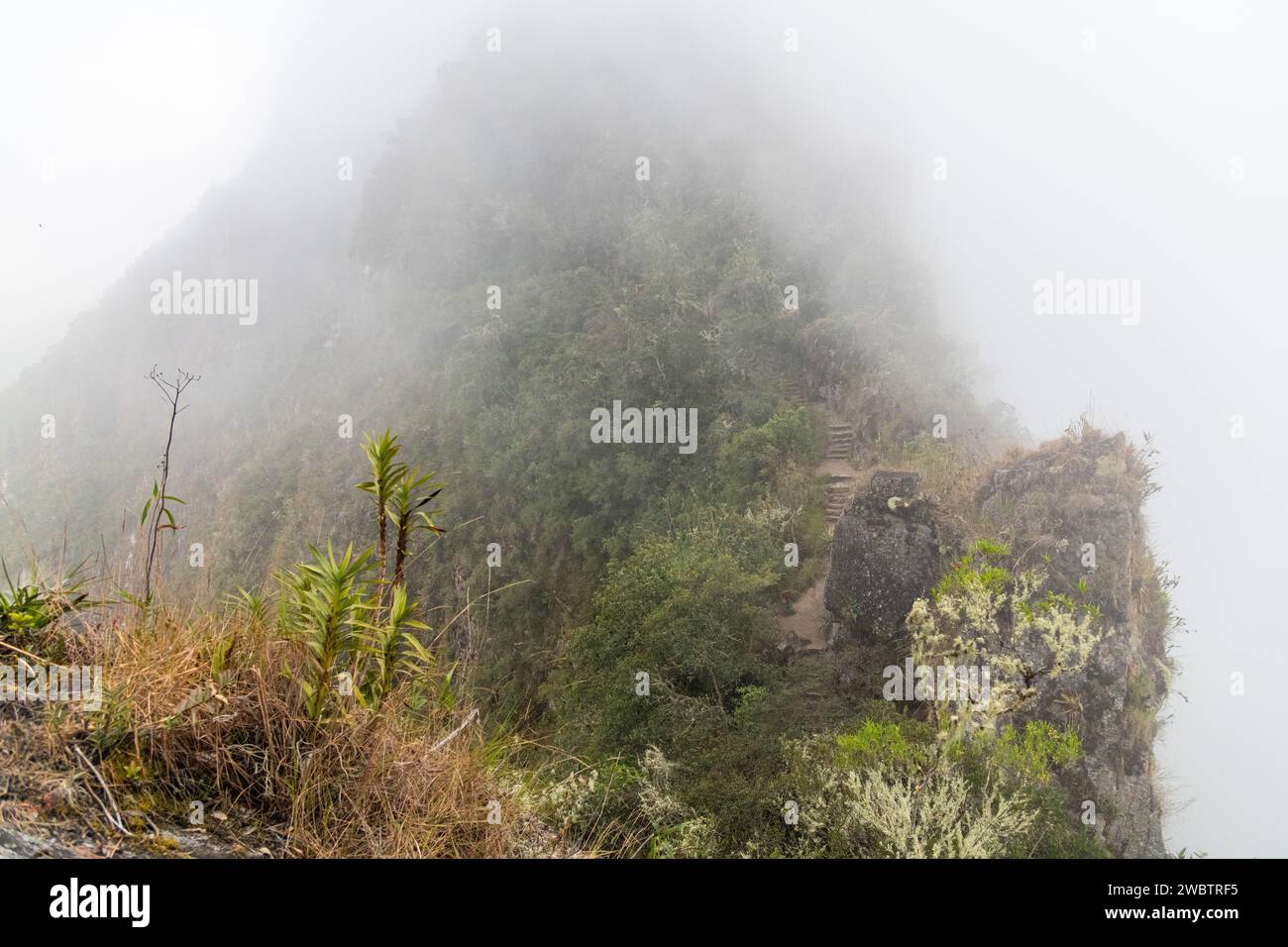 A cloudy view of Huayna Picchu mountain at Machu Picchu in Peru Stock Photo