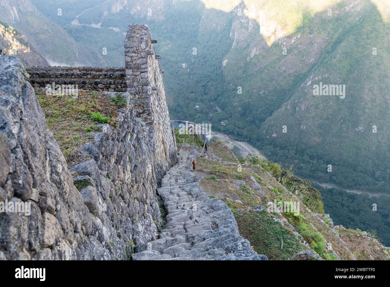 Stone steps on the path / trail leading up to the top of Huayna Picchu mountain at Machu Picchu in Peru Stock Photo