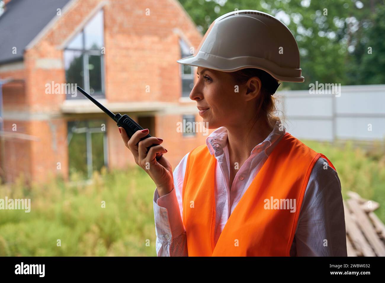 Building inspector using two-way radio on development site Stock Photo