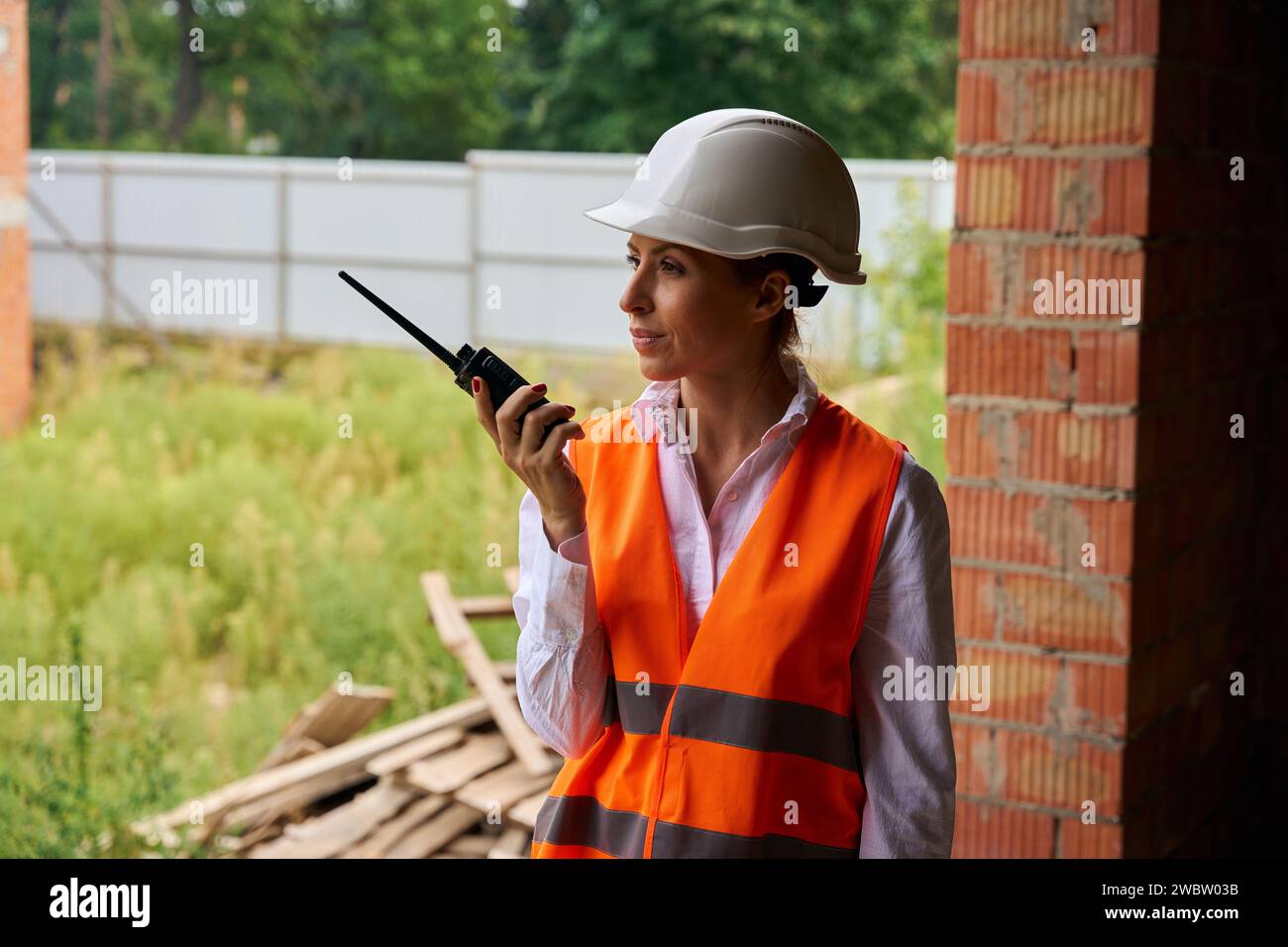 Serious construction manager using radio communication on development site Stock Photo