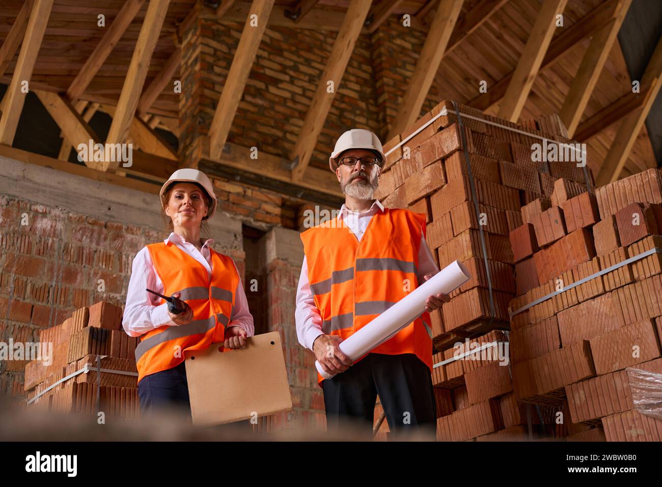 Site supervisor and foreman posing for camera during construction inspection Stock Photo