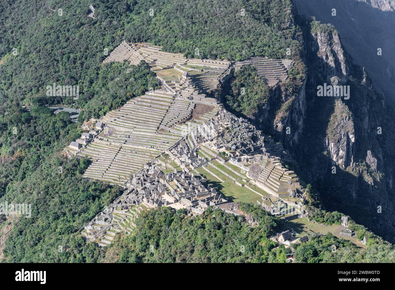 A close up view of Machu Picchu from the top of Huayna Picchu mountain peak on a clear sunny day in the Sacred Valley in Peru Stock Photo