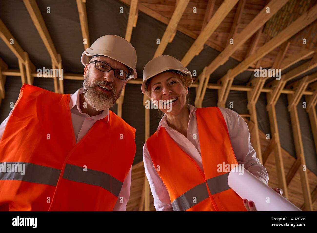 Foreman and construction supervisor posing for camera during house inspection Stock Photo
