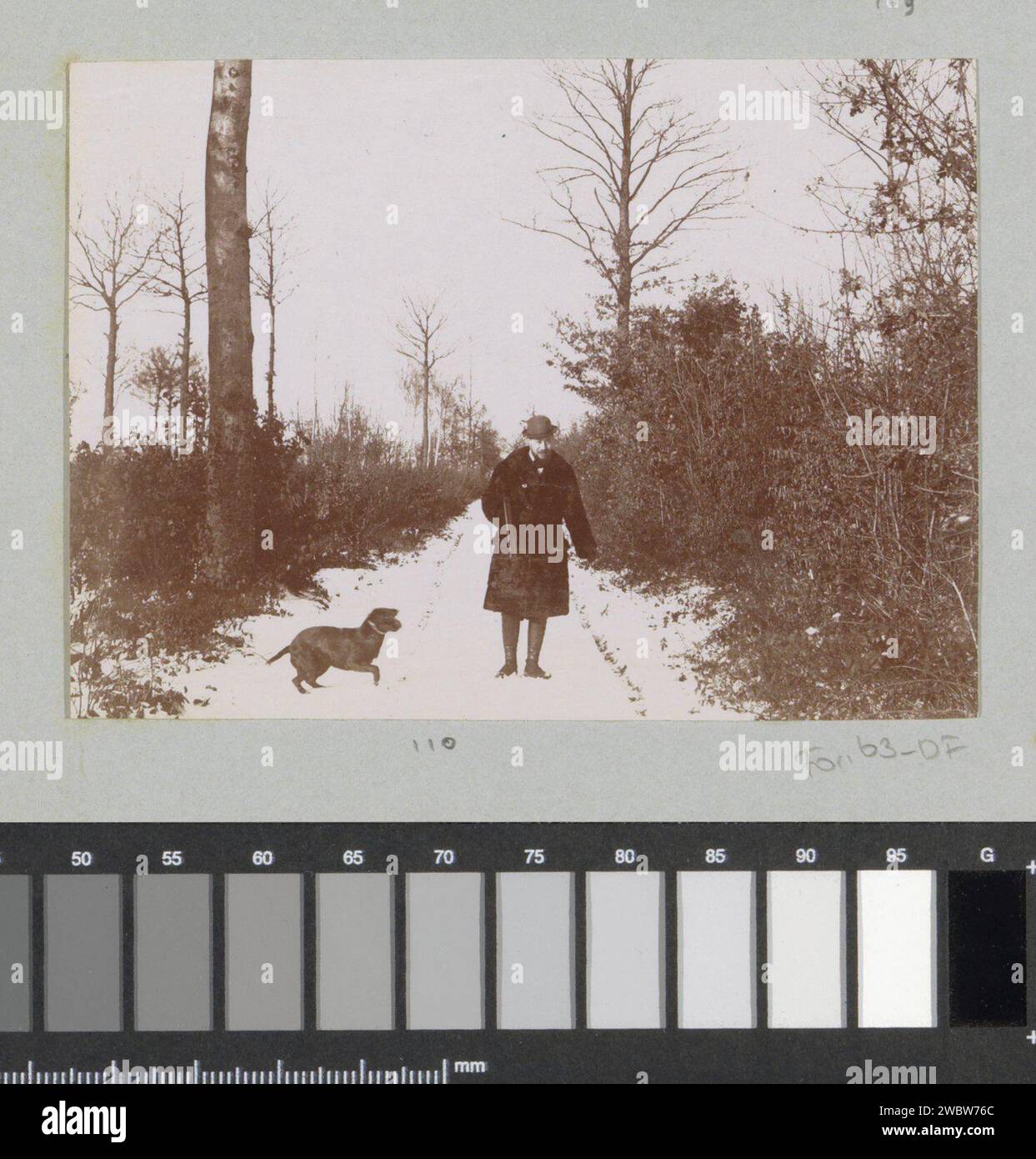 Hunter with dog on snowy path, presumably at Arcachon, 1897 photograph Part of photo album of a French amateur photographer with recordings of trips in France, Spain, Belgium, Luxembourg and the Netherlands, the first cars and car races. Arcachon paper. photographic support  forest path or lane. snow. hunter. hunting dogs Arcachon Stock Photo