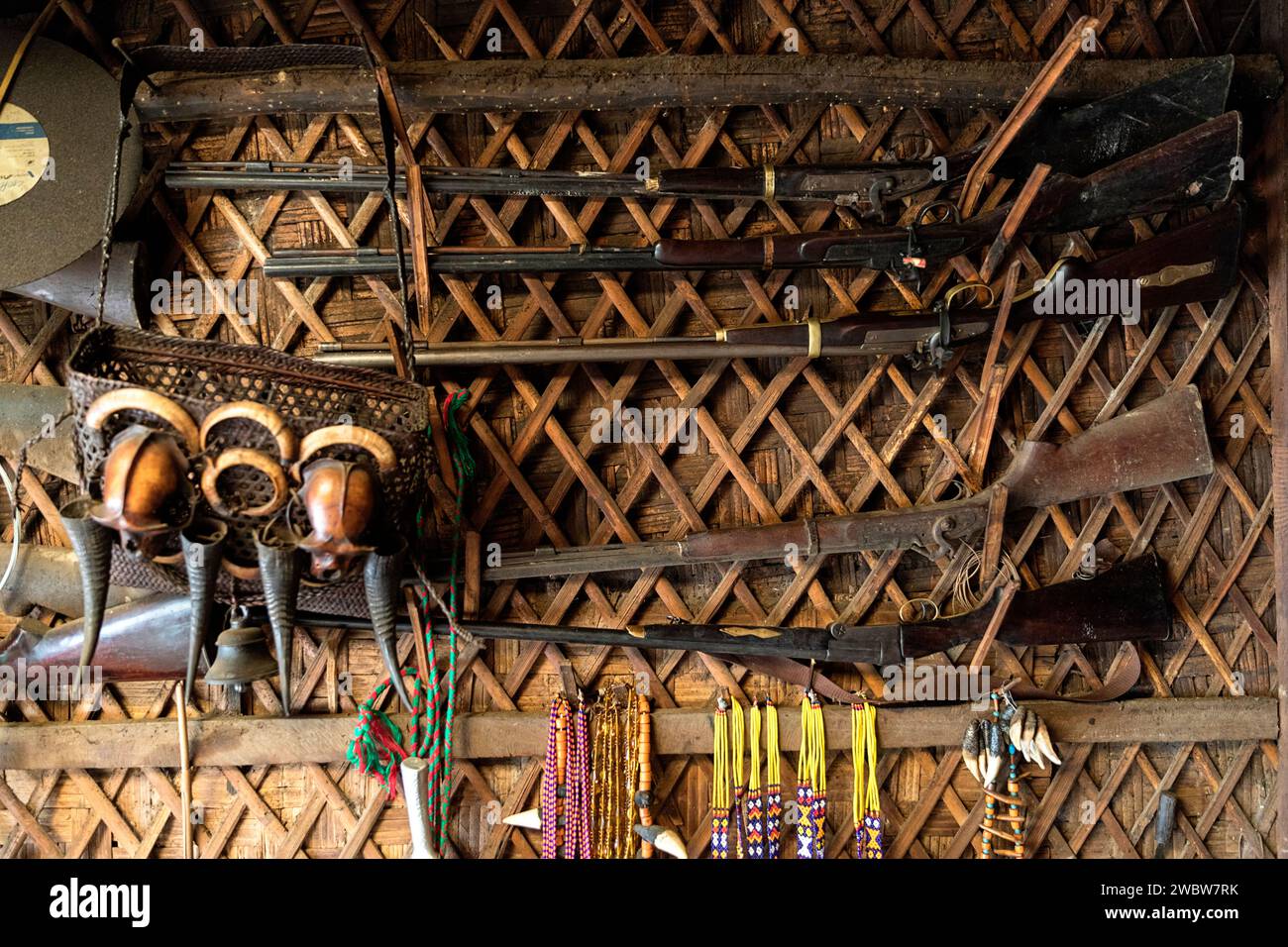 Local gunsmith workshop in a border village of Longwa on India Myanmar border, skulls of monkeys on a wall with handmade guns for display Stock Photo