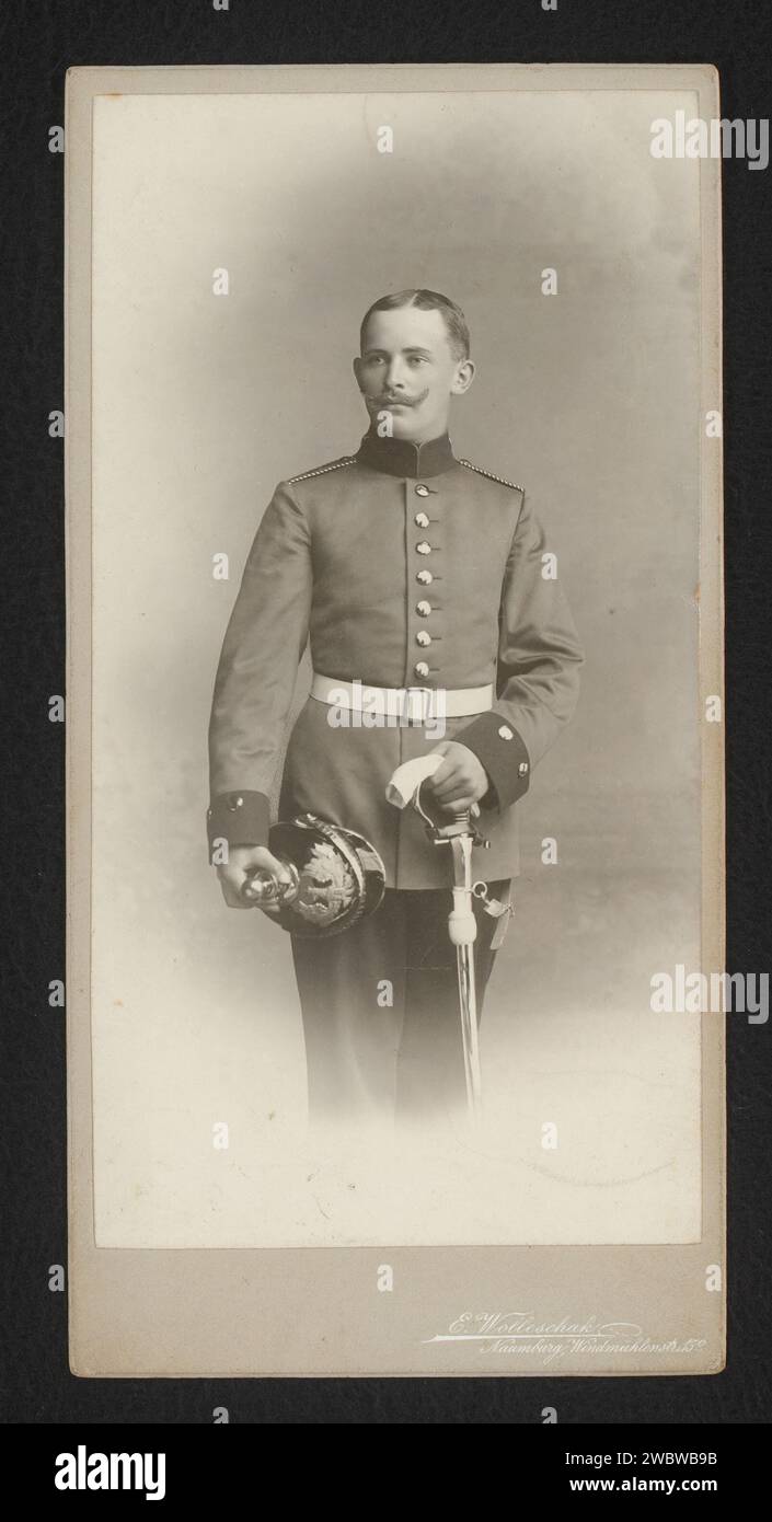 Portrait of a standing man in military uniform with saber and helmet, E ...
