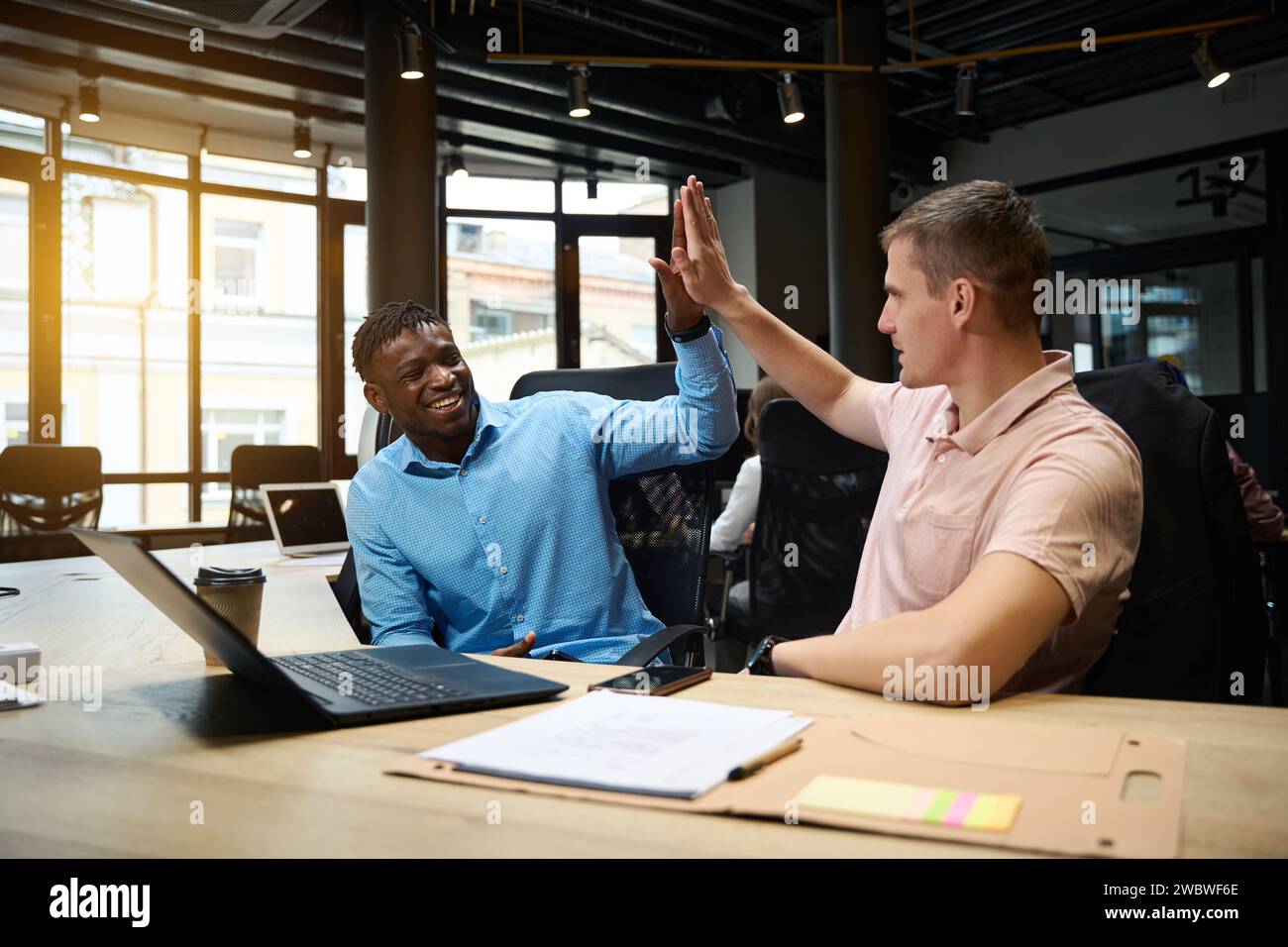 Successful male colleagues web-developers giving high five ending ...