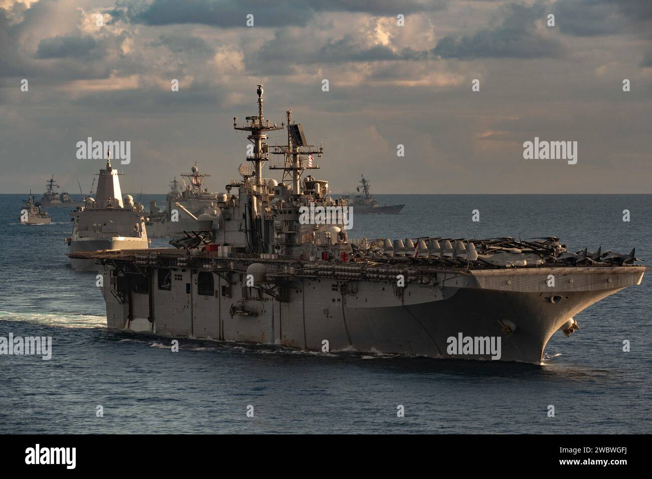 Mediterranean Sea, United States. 31 December, 2023. The U.S. Navy Wasp-class amphibious assault ship USS Bataan leads a formation of ships from the Bataan Amphibious Ready Group and Gerald R. Ford Carrier Strike Group during maritime security patrol in support of Operation Prosperity Guardian, December 31, 2023 in the Mediterranean Sea. OPG is a multinational coalition to support maritime security and counter attacks on commercial shipping in the region.  Credit: MC2 Nolan Pennington/U.S. Navy Photo/Alamy Live News Stock Photo