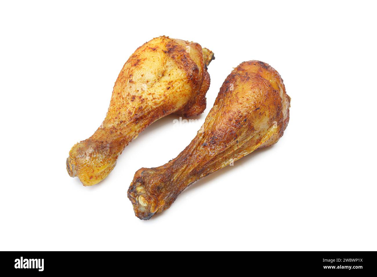 Two roasted and marinated chicken drumstick thigh legs isolated on