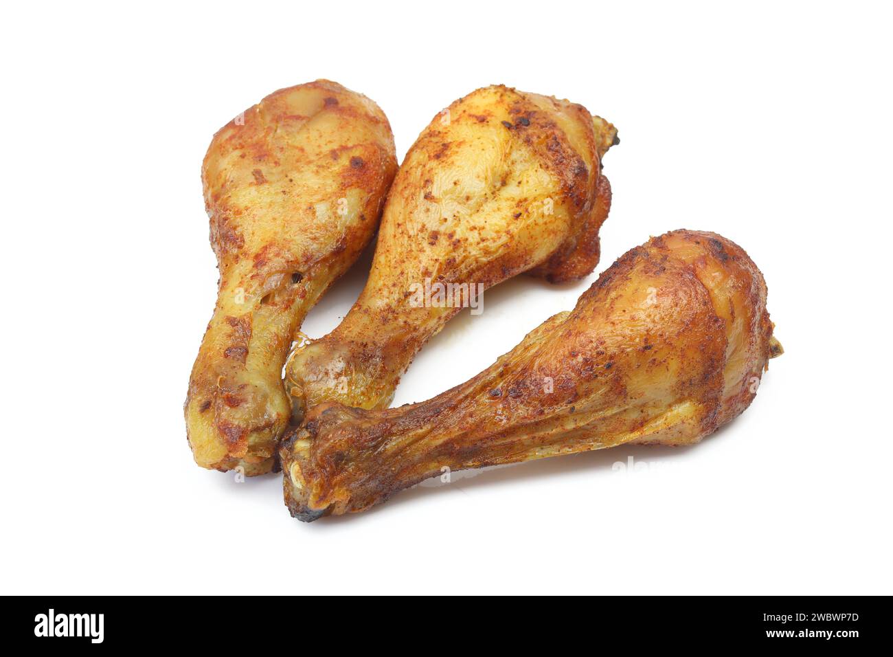 Three roasted and marinated chicken drumstick thigh legs isolated on