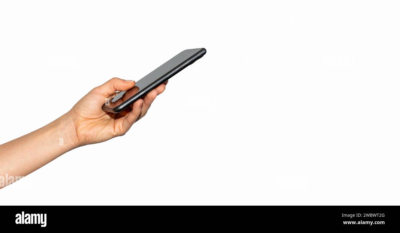 Isolated female hand with black unrecognisable smart phone. Cellphone in hand. Stock Photo