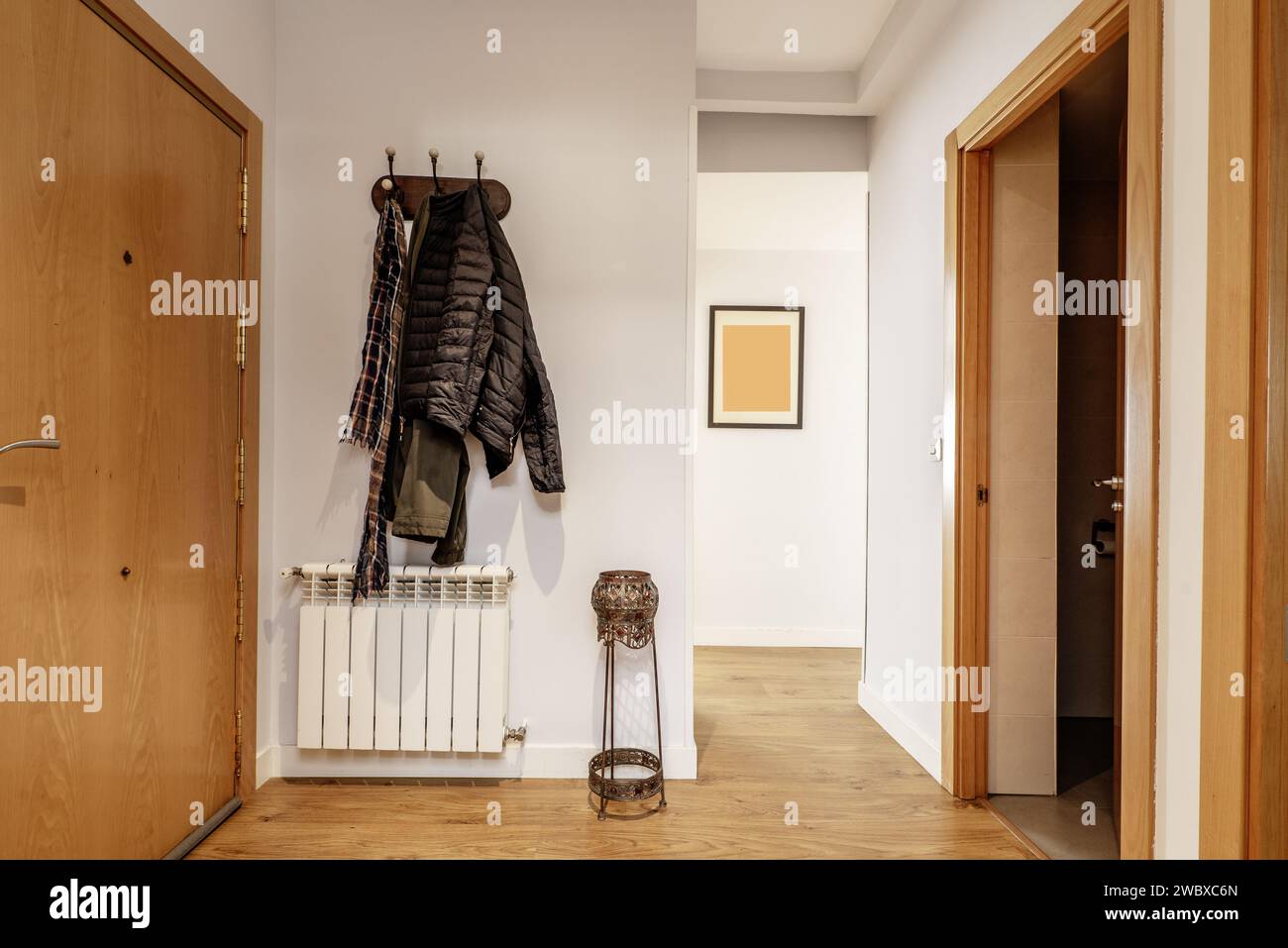 Hallway of a home with armored access door, an aluminum radiator