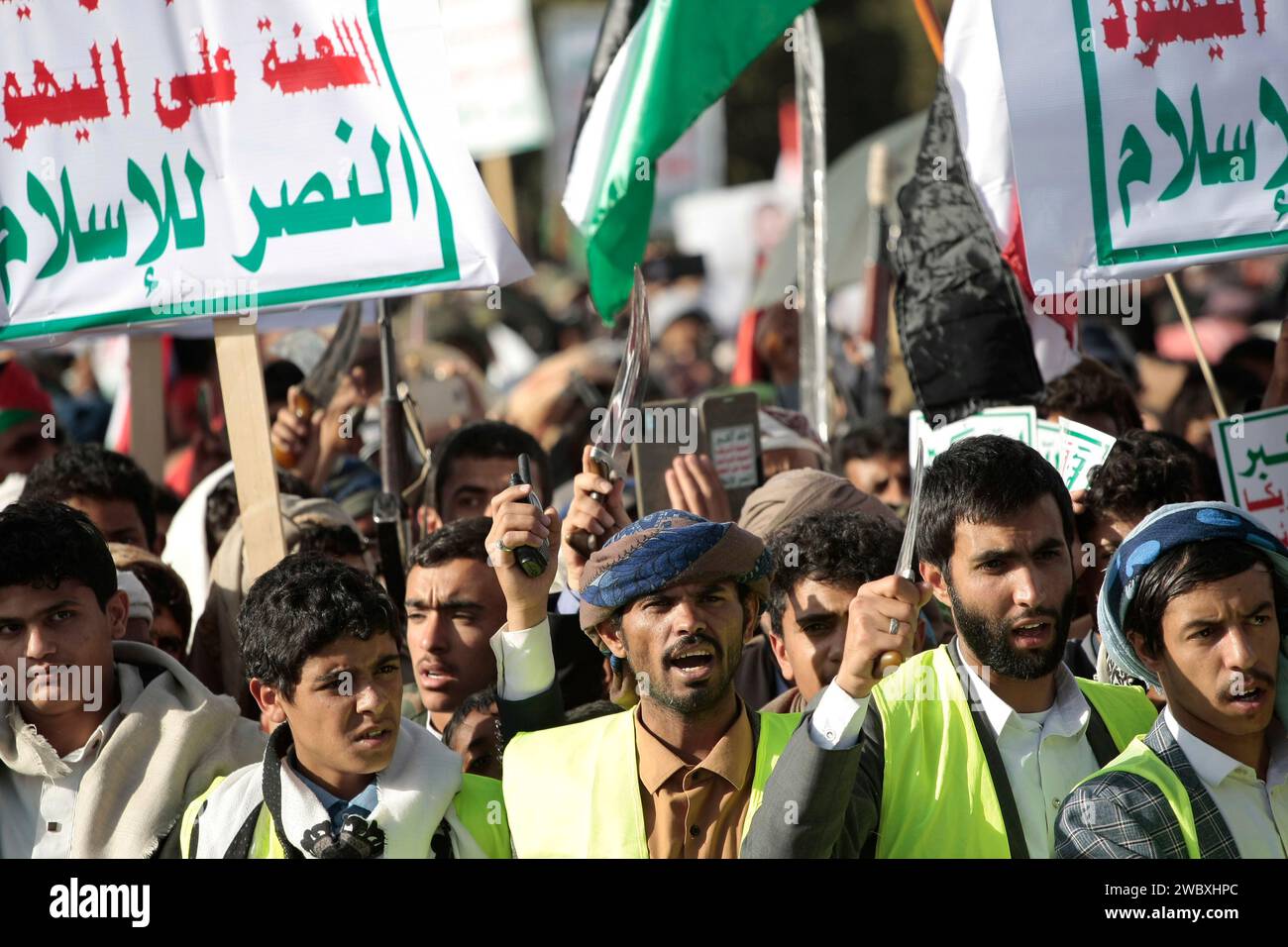 Sanaa Sanaa Yemen 12th Jan 2024 A People Hold Up Guns Wave A   Sanaa Sanaa Yemen 12th Jan 2024 A People Hold Up Guns Wave A Palestinian Flag And Chant Slogans During Demonstrate Against Multinational Operation To Safeguard Red Sea Shipping Following Us And Uk Airstrikes On Houthis Military Sites In Sanaa Yemenin A Statement Made By Houthi Military Spokesperson Yahya Sarea It Was Reported That Five Houthi Fighters Lost Their Lives And Six Others Sustained Injuries During 73 Airstrikes Conducted By The United States And The United Kingdom On Multiple Houthi Controlled Locations In Yemen This Retaliation Was In Response To The Houthis Attac 2WBXHPC 