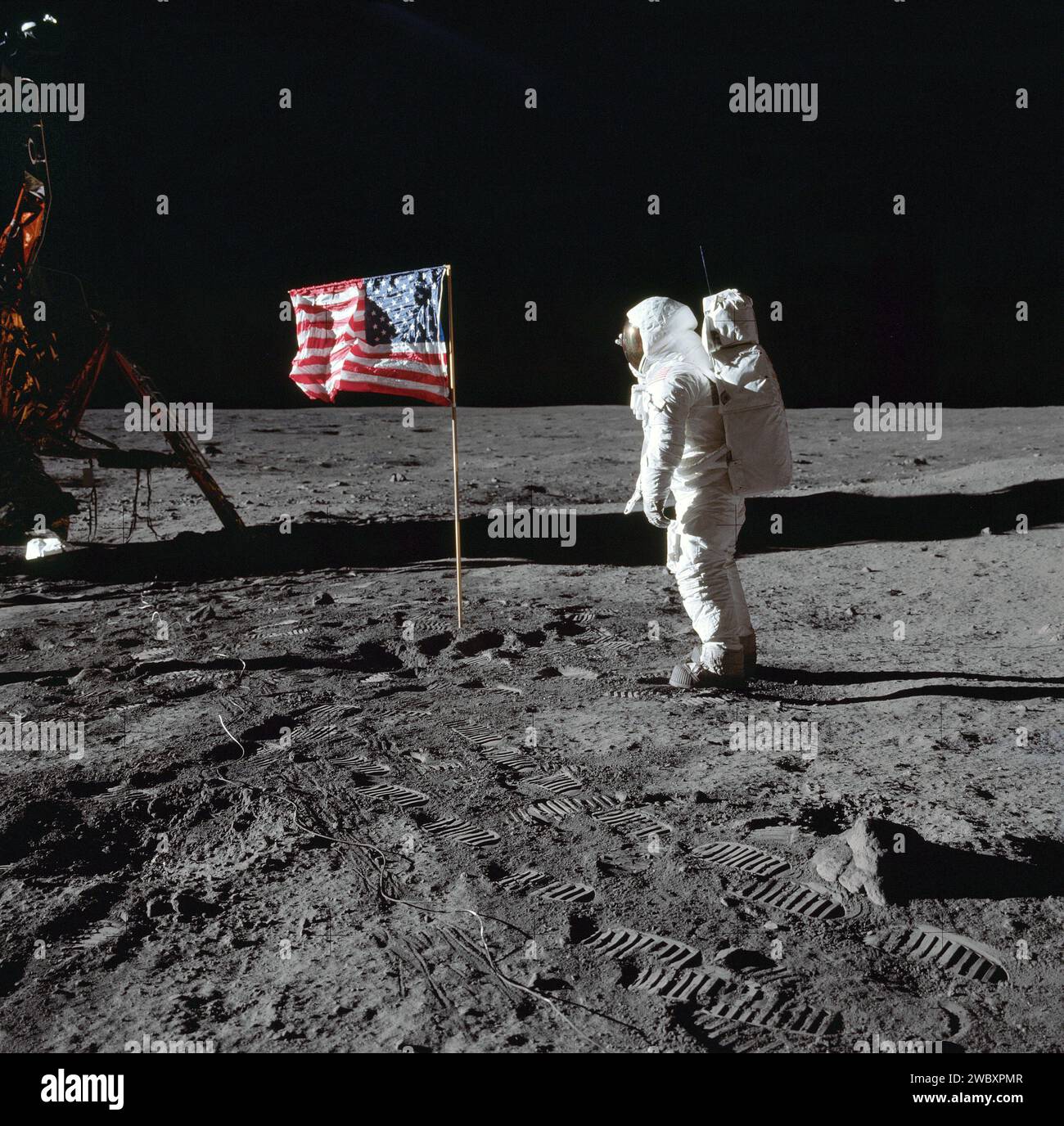 American Astronaut Edwin E. Aldrin Jr., lunar module pilot of first lunar landing mission, near United States flag during Apollo 11 extravehicular activity on moon surface, photo by Neil Armstrong, Johnson Space Center, NASA July 21, 1969 Stock Photo