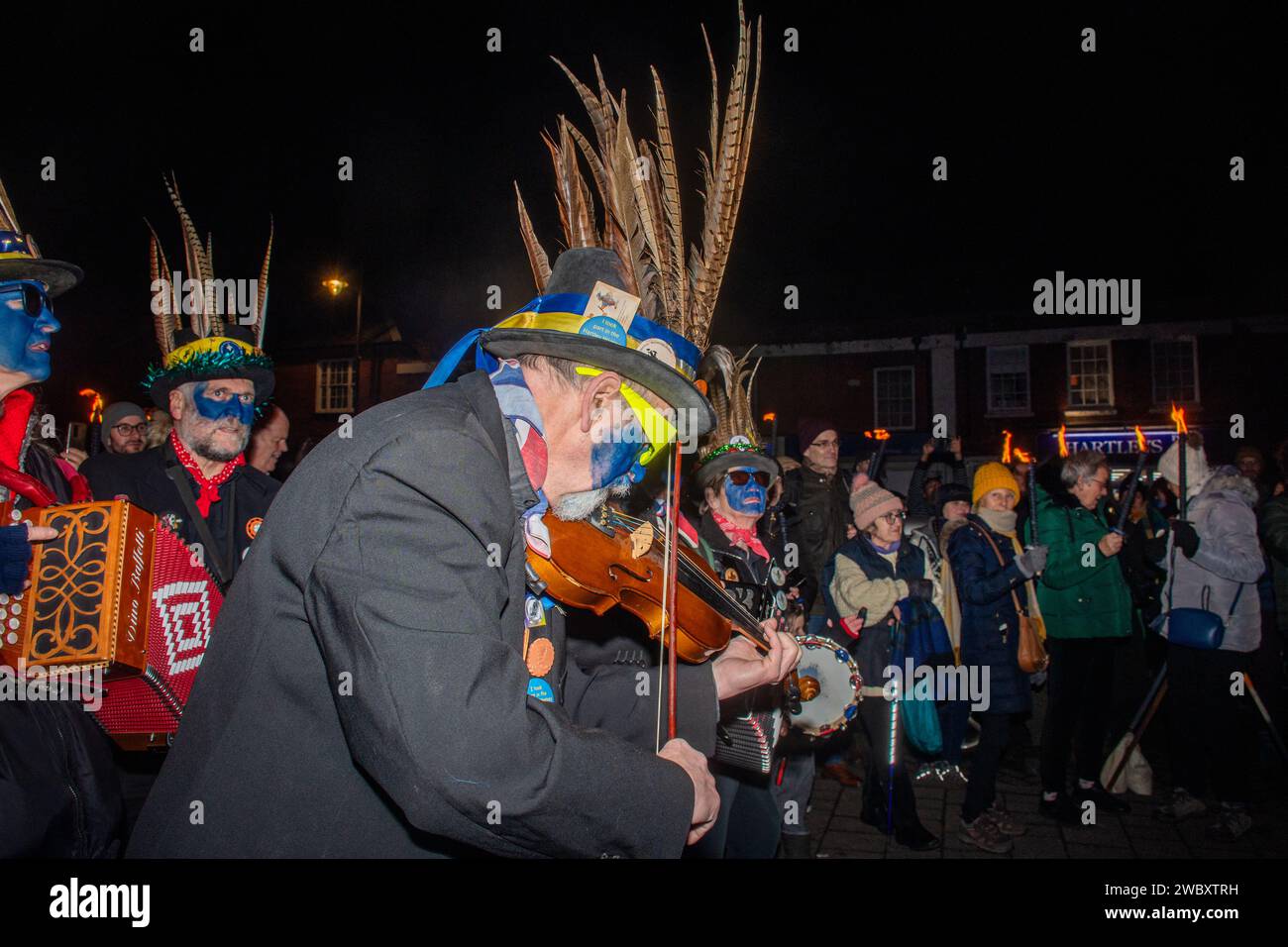 12th January 2024. The annual apple orchard wassail took place in Hartley Wintney village, Hampshire, England, UK. The Hook Eagle Morris group started the evening outside the Waggon and Horses Pub with a morris dancing display, with cider available to the public. This was followed by a torch procession to the orchard, with traditional singing and wassailing and pieces of toast were placed on an apple tree to promote a good harvest for the coming year. Stock Photo