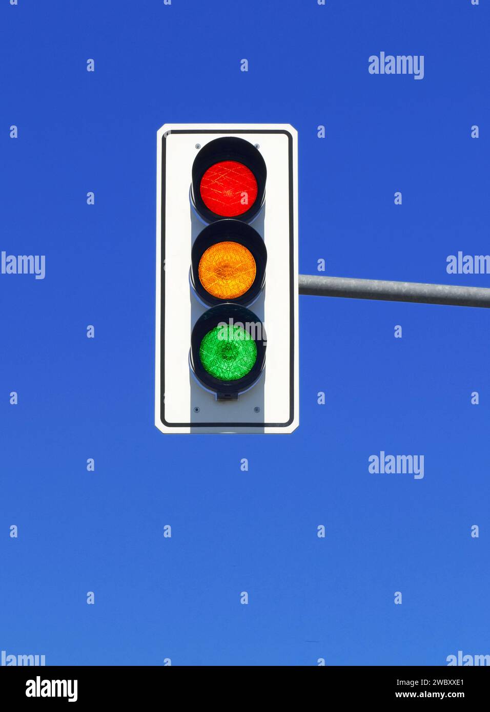 traffic light in blue sky with red, yellow and green lights on Stock