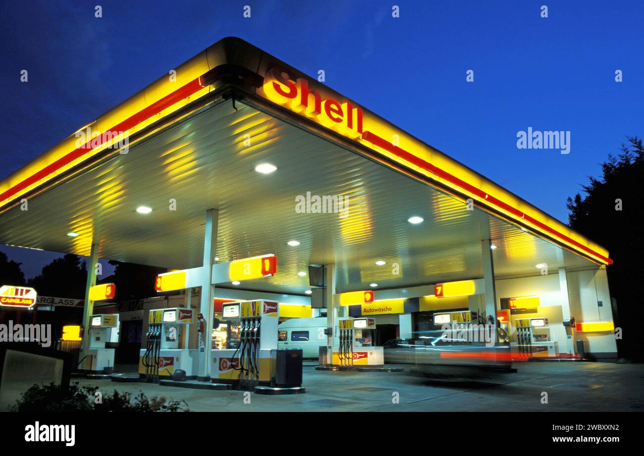 Shell Gas Station at sunset or night, a car entering, motion blur