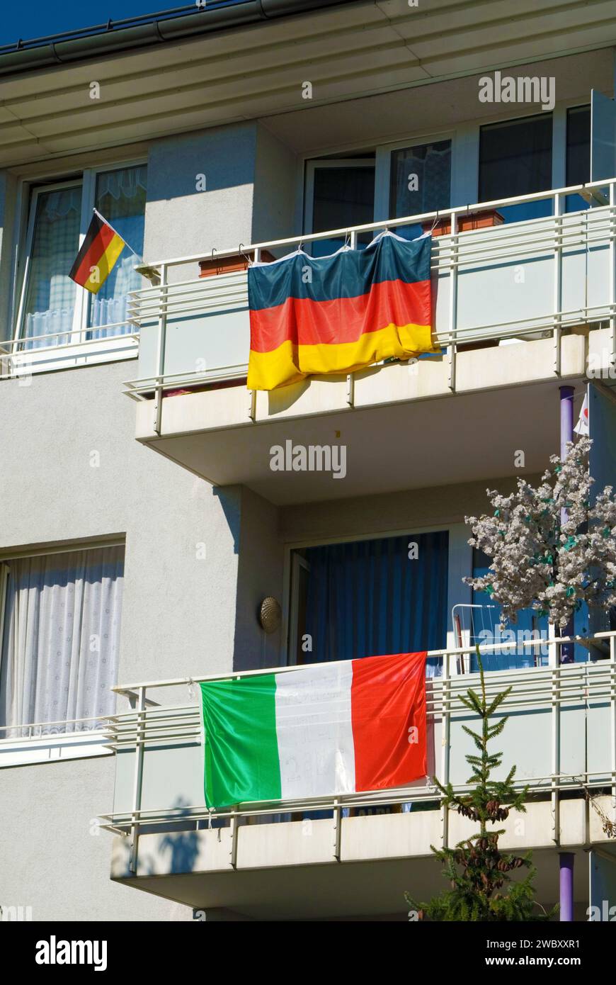 national flags of Germany and Italy fixed at balcony railings of a Revenue House, while soccer world championship 2006, Munich, Bavaria, Germany Stock Photo