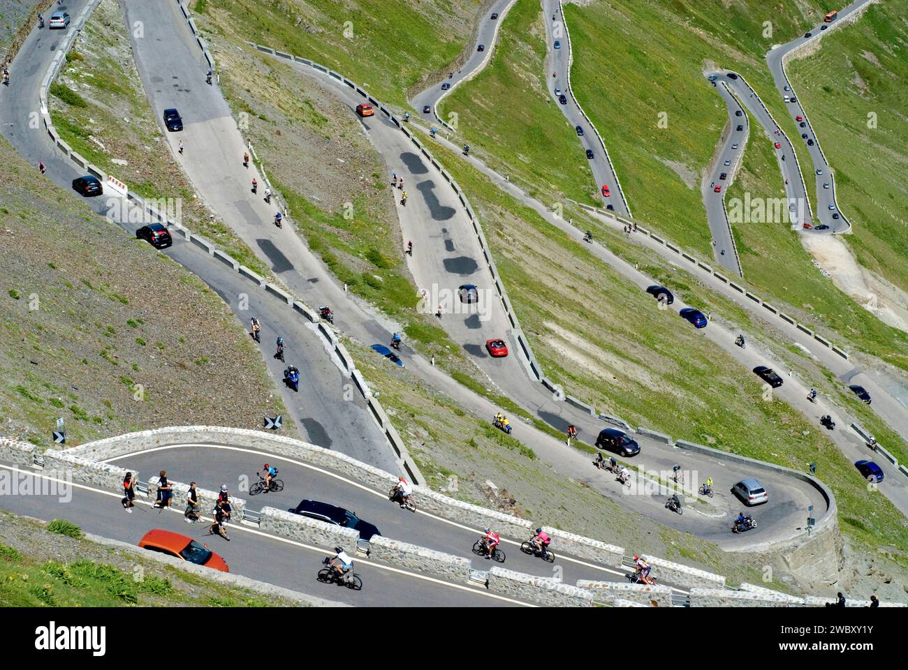 much traffic on Stelvio Pass in the summer season, busy and crowded with pedestrians, bikers, cars, traffic jam , South Tyrole, Alps Stock Photo