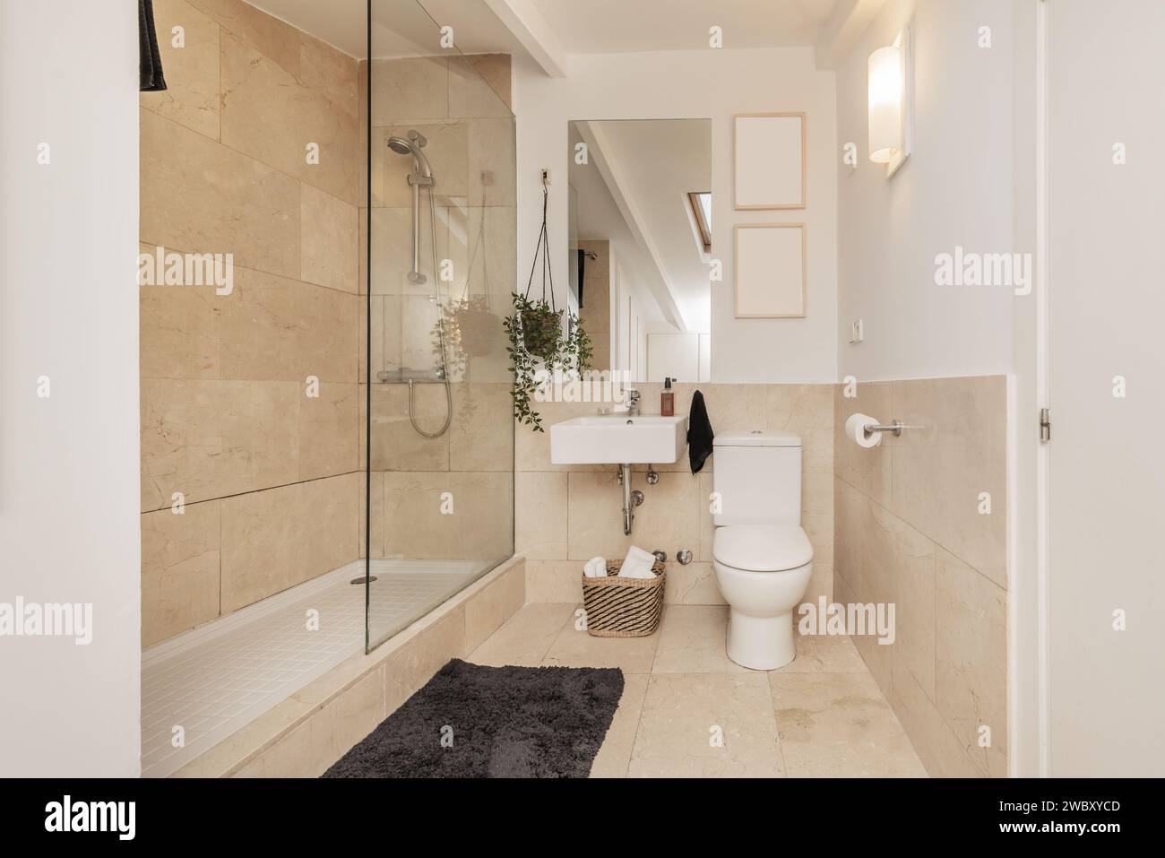 A bathroom with white square porcelain sink with frameless mirror