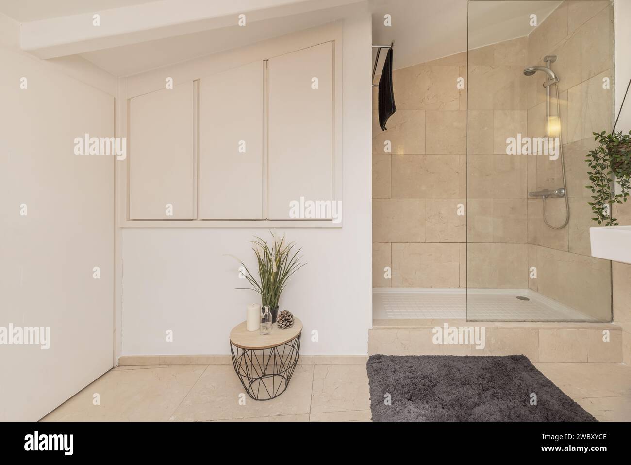 A bathroom with a white glassenclosed shower cubicle and