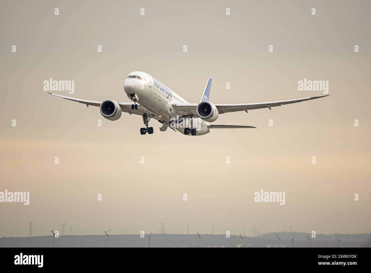 Climbing of a passenger plane just as the landing gear is retracting