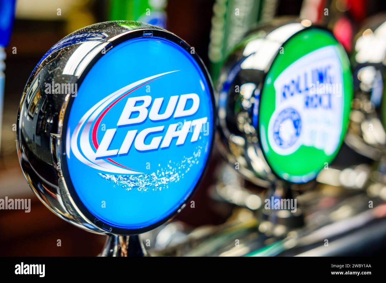 American beer, beer branding, Bud Light beer tap, lager beer pump handle in a bar, pub beer serving counter showing budlight brand and beer taps, USA Stock Photo