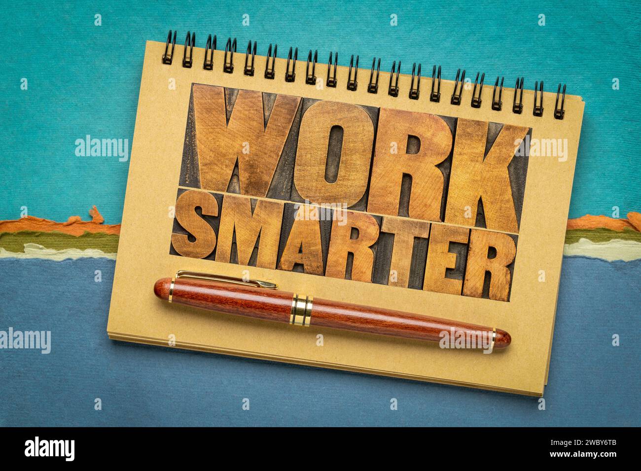 work smarter word abstract - motivational advice or reminder - text in letterpress wood type in a sketchbook, business productivity and efficiency con Stock Photo