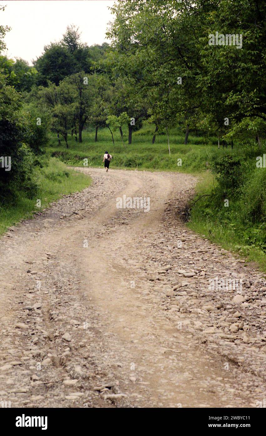 Unpaved Path Vrancea County, Romania, approx. 1999. Elderly woman walking on an ...