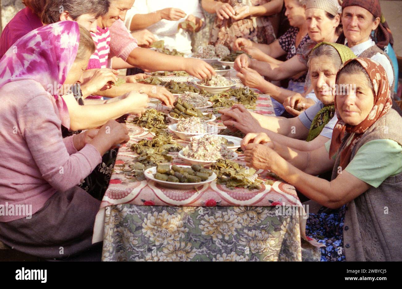 Vrancea County, Romania, approx. 1998. A group of local women preparing the traditional grape leaves rolls for an event. Stock Photo
