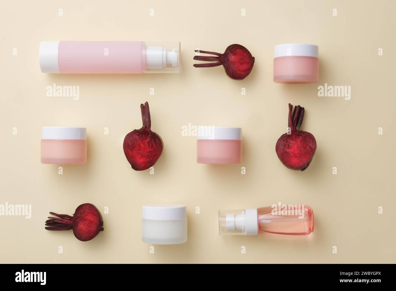 Several types of cosmetic containers are arranged with halves of