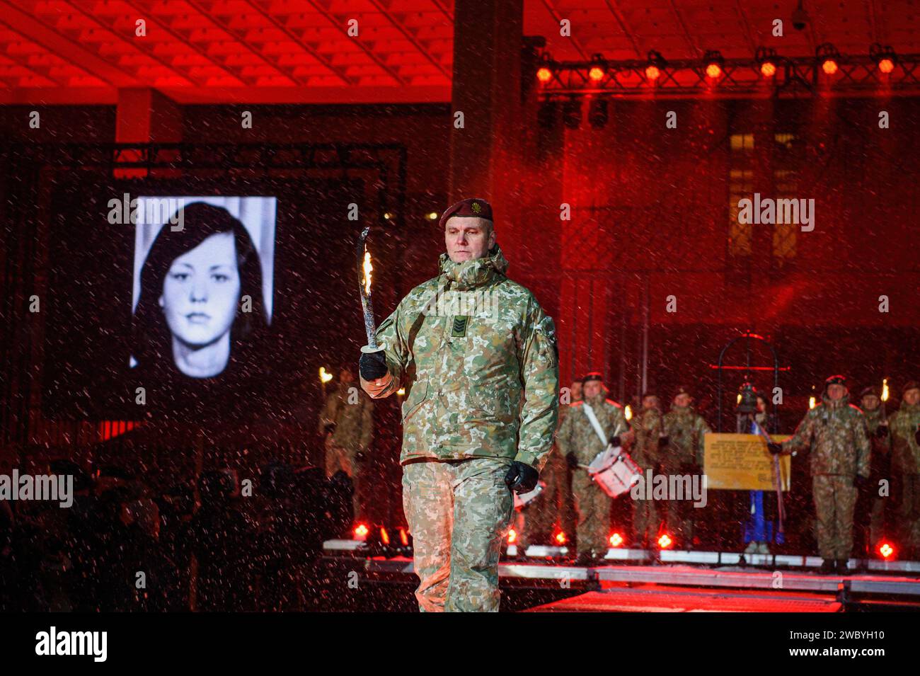 Lithuanian soldier holds a torch to light a bonfire at the Independence Square near the Lithuanian Parliament building on the eve of the 33rd anniversary of the Day of the Defenders of Freedom in Vilnius. People gathered around the bonfire to remember the victims of assault by Soviet troops on the television center in Vilnius in 1991. The incident resulted in 14 deaths with many injured. The ceremonial lighting of bonfires took place near the Vilnius TV tower and at Independence Square. (Photo by Yauhen Yerchak/SOPA Images/Sipa USA) Stock Photo