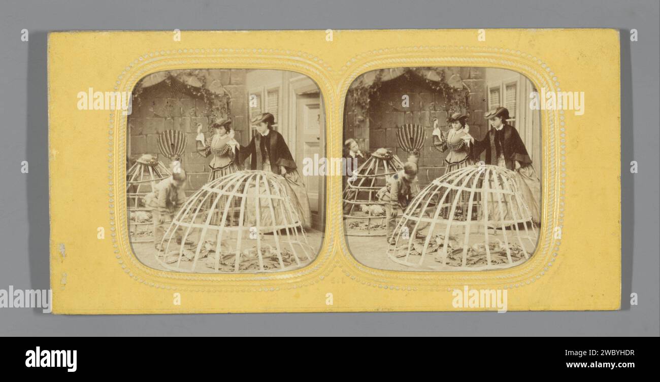 Two boys with bird cages converted crinoliner socks, two angry women in background, Anonymous, 1865 tissue stereograph   photographic support. paper. cardboard albumen print bird in a cage Stock Photo