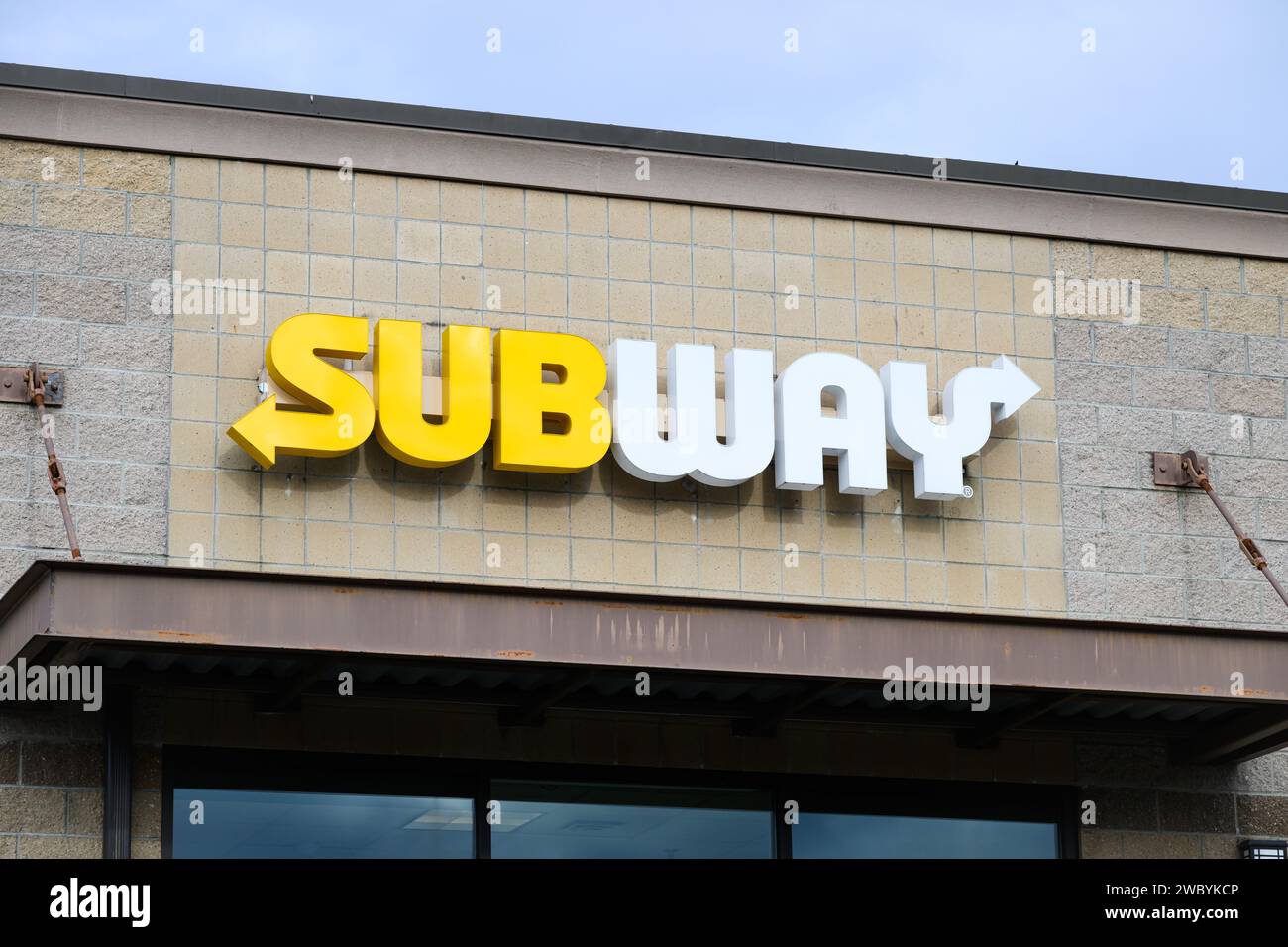 Monroe, WA, USA - January 3, 2024; Yellow and white brand sign for Subway fast food restaurant Stock Photo