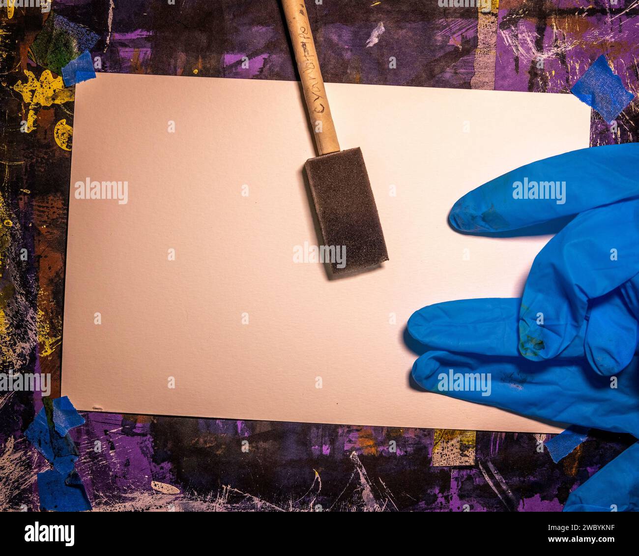Sensi tizing paper with light sensative Cyanotype mixture with small sponge brush. Stock Photo