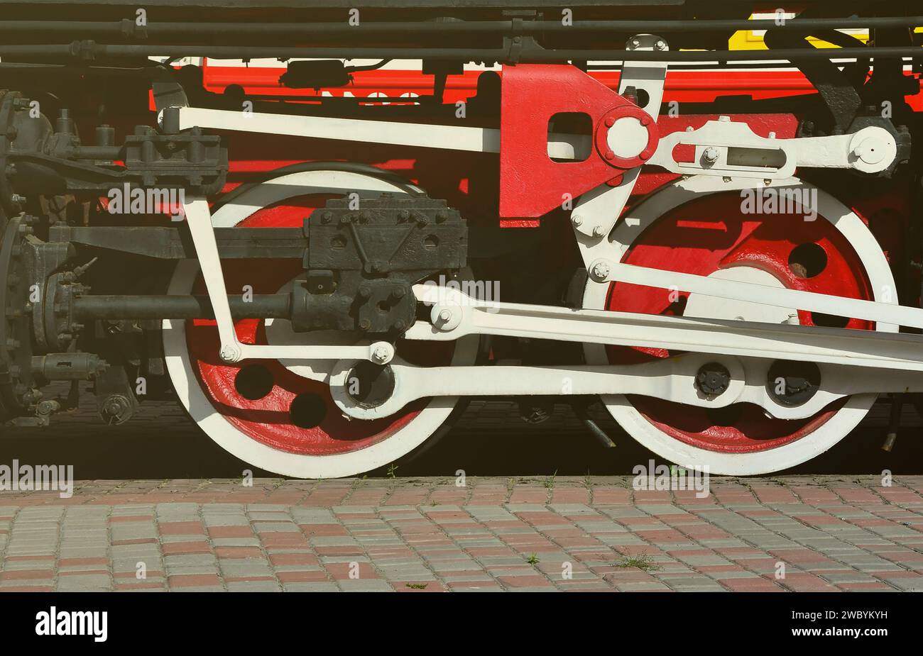 Wheels of the old black steam locomotive of Soviet times. The side of ...