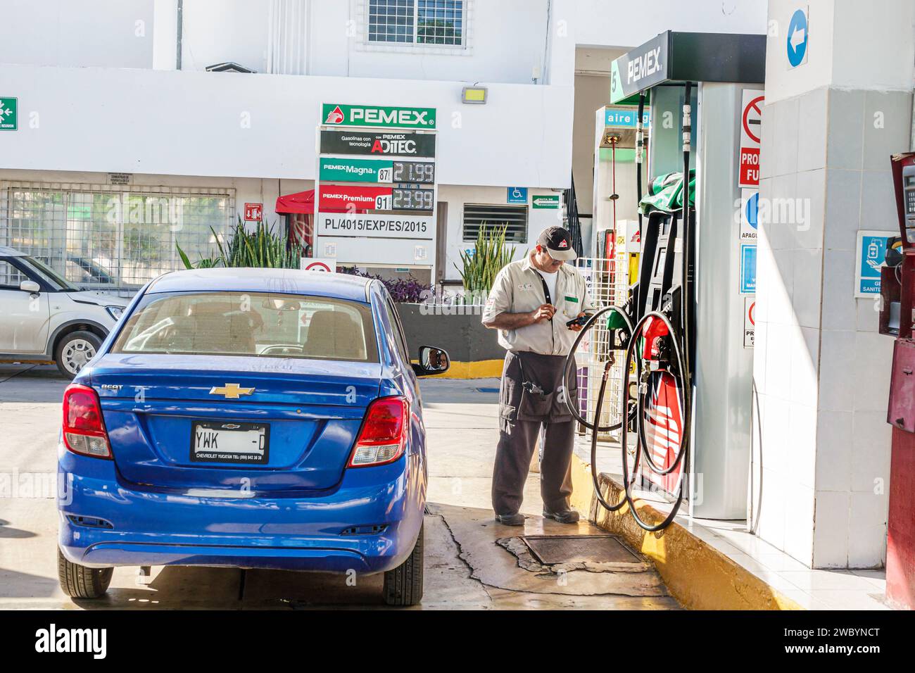 Merida Mexico,centro historico central historic district,PEMEX gas petrol filling station pumps,attendant,Chevy Chevrolet Beat hatchback GM Korea,car Stock Photo