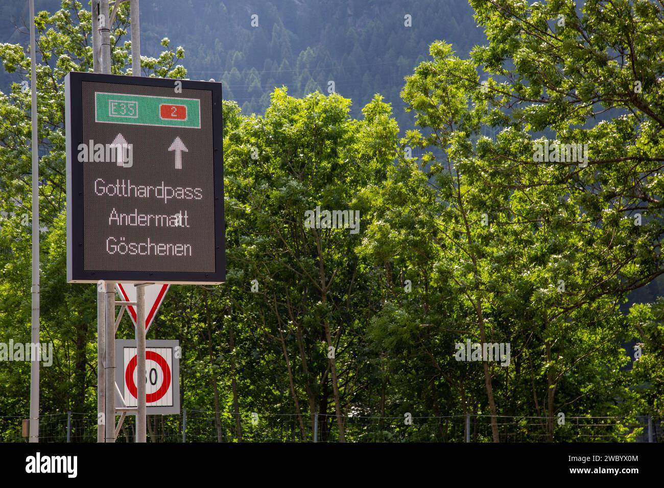 A road sign near Wassen, Switzerland, directs travelers to Gotthard Pass, Andermatt and Göschenen. Stock Photo