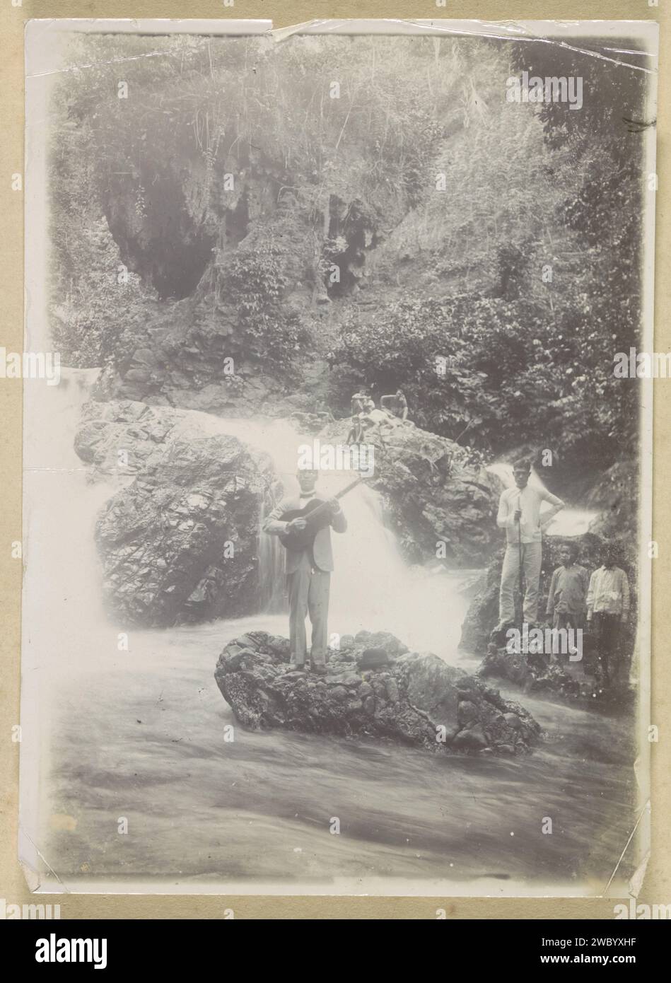 Playing guitar at a waterfall at Batoe Gantong on Ambon, Anonymous, c ...