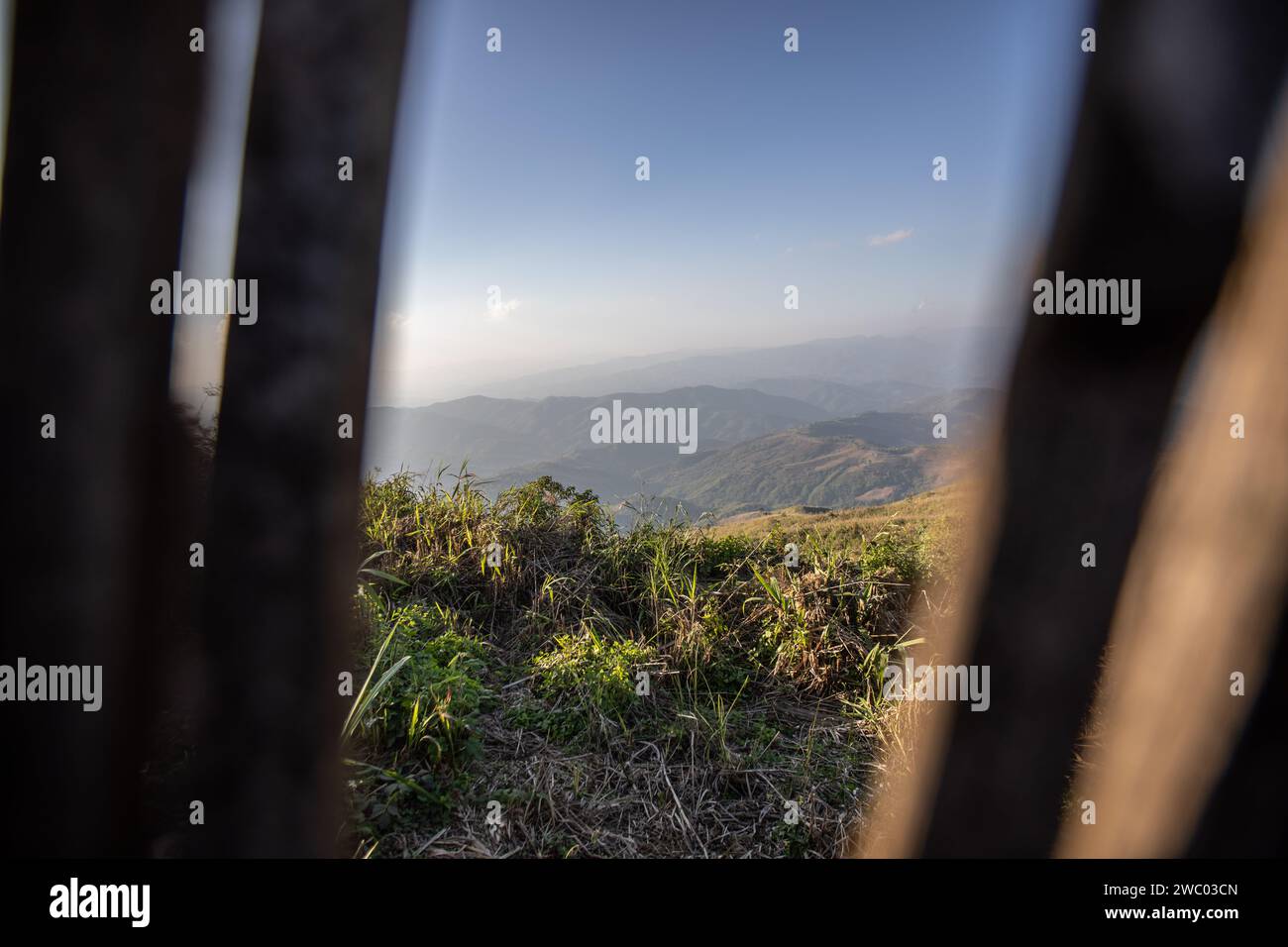 A view of Myanmar through high bamboo fences before entering the Chang Moob Military Outpost. The Chang Moob Military Outpost now turned into a tourist attraction spot, used to be a Thai Royal Army location to prevent drug smuggling and keep an eye on other suspicious activities on the Myanmar side (mostly in the 1990s). Also called the 'Doi Tung Trenches' It starts off with a narrow pathway through high bamboo fences before reaching the main spot with deep trenches along the northernmost sections of the Thai-Myanmar border, with a stunning view of Myanmar mountains. (Photo by Guillaume Payen Stock Photo