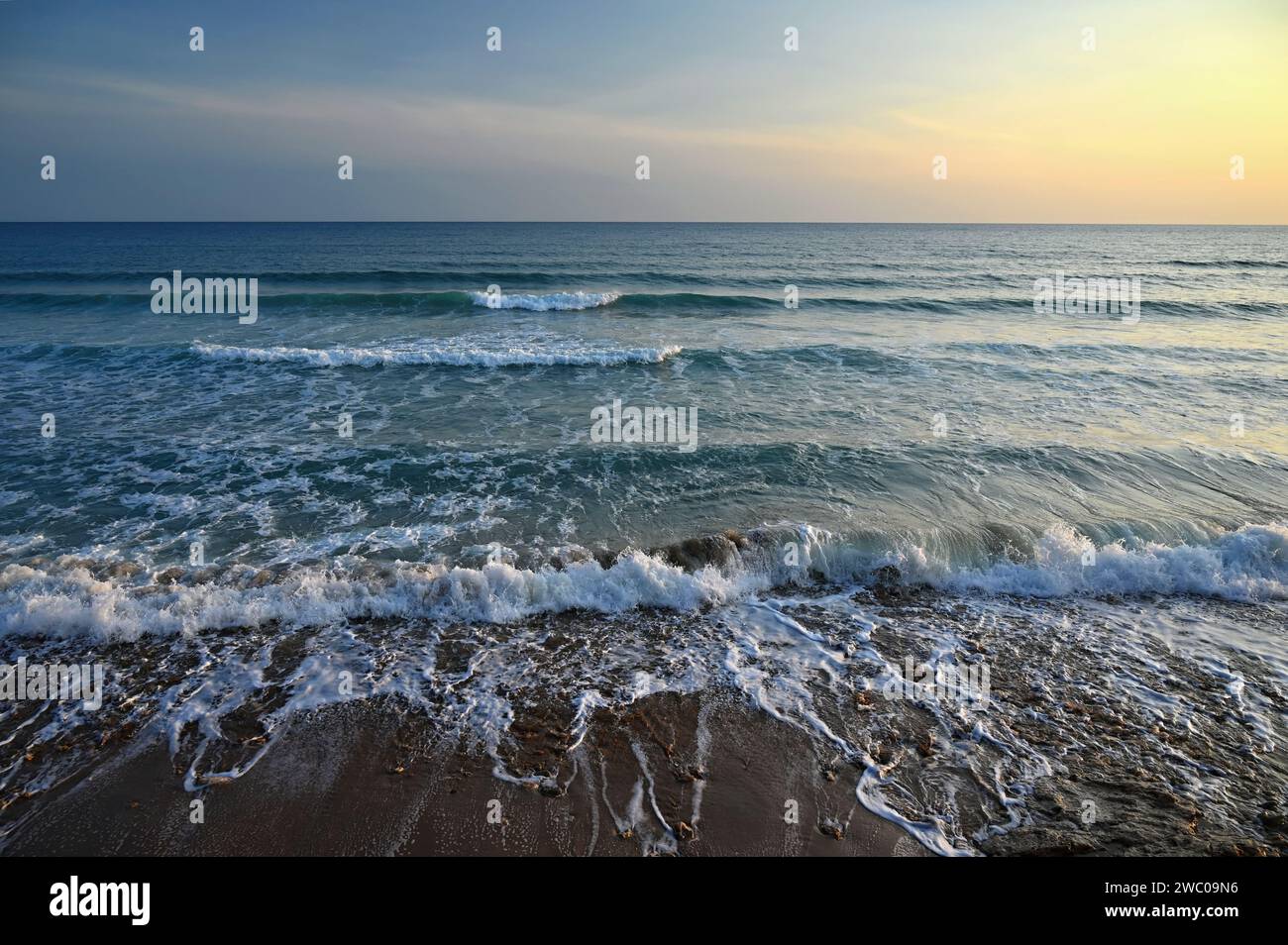 Sea at sunset with waves on the beach. Greece - the island of Corfu. Stock Photo