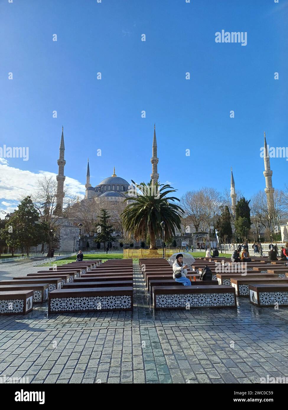 Istanbul Turkey January 08 2024 A Group Of People Sit In The   Istanbul Turkey January 08 2024 A Group Of People Sit In The Courtyard Of The Blue Mosque In Istanbul 2WC0C59 